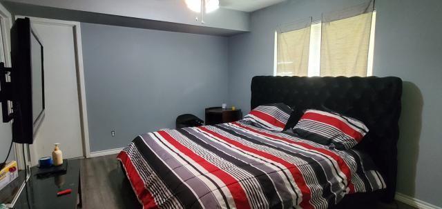 918 Greenbriar Dr, Garland, TX 75043 - bedroom featuring baseboards and wood finished floors