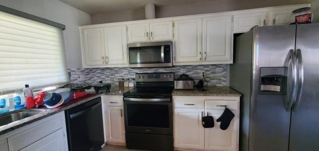 918 Greenbriar Dr, Garland, TX 75043 - kitchen featuring appliances with stainless steel finishes, backsplash, white cabinets, and a sink