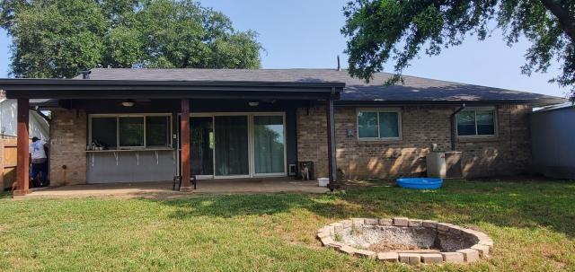 918 Greenbriar Dr, Garland, TX 75043 - back of property featuring an outdoor fire pit, a patio, and a lawn