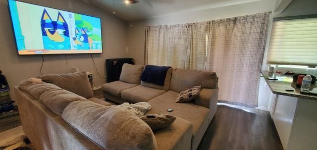 918 Greenbriar Dr, Garland, TX 75043 - home theater room featuring wood finished floors and lofted ceiling