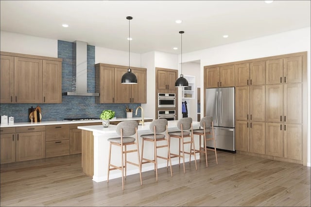 8425 Peach, Justin, TX 76247 - kitchen featuring stainless steel appliances, wall chimney range hood, a breakfast bar area, tasteful backsplash, and light wood finished floors