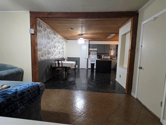 212 W 7th St, Lancaster, TX 75146 - living area with a wainscoted wall, ceiling fan, dark tile patterned floors, wood ceiling, and baseboards