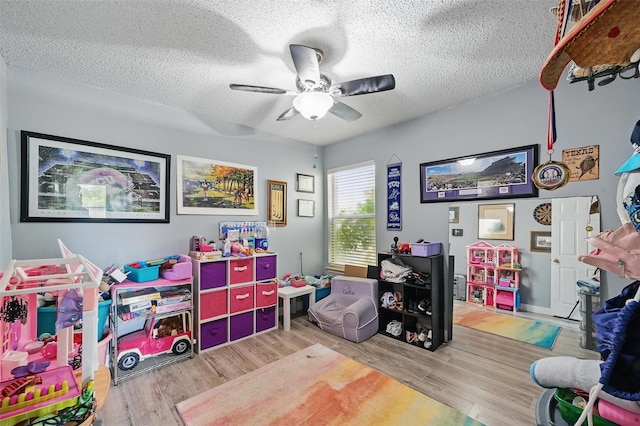 2748 Yoakum St, Fort Worth, TX 76108 - rec room with wood finished floors, a textured ceiling, and a ceiling fan