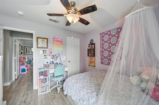 2748 Yoakum St, Fort Worth, TX 76108 - bedroom with wood finished floors, a ceiling fan, and a textured ceiling