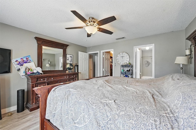 2748 Yoakum St, Fort Worth, TX 76108 - bedroom featuring light wood-type flooring, baseboards, a ceiling fan, and a textured ceiling