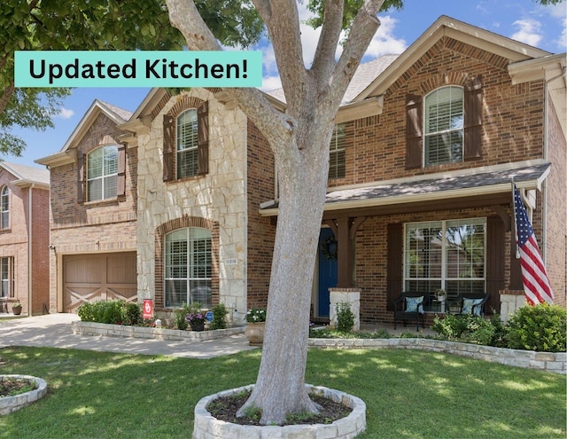 11310 Seguin Dr, Frisco, TX 75035 - view of front of home with stone siding, brick siding, a front lawn, and an attached garage
