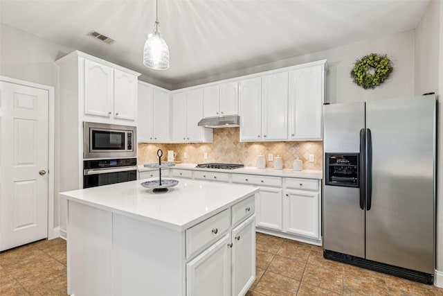 11310 Seguin Dr, Frisco, TX 75035 - kitchen featuring stainless steel appliances, under cabinet range hood, backsplash, white cabinetry, and light countertops