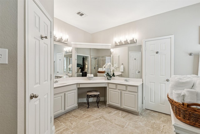 11310 Seguin Dr, Frisco, TX 75035 - bathroom with a shower stall, double vanity, and stone finish flooring
