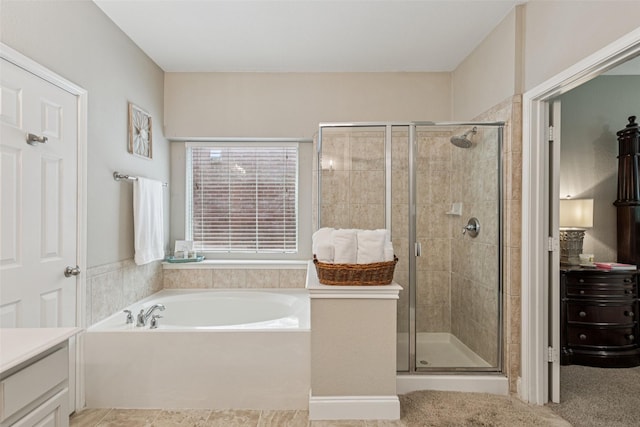 11310 Seguin Dr, Frisco, TX 75035 - full bathroom with vanity, a garden tub, and a stall shower