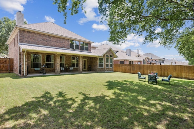 11310 Seguin Dr, Frisco, TX 75035 - back of property with brick siding, a chimney, a patio, and roof with shingles