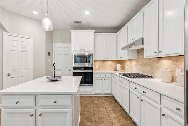 11310 Seguin Dr, Frisco, TX 75035 - kitchen with appliances with stainless steel finishes, under cabinet range hood, decorative backsplash, white cabinetry, and recessed lighting