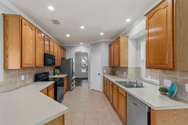 1106 Brook Ridge Ave, Allen, TX 75002 - kitchen featuring black appliances, a sink, arched walkways, backsplash, and recessed lighting