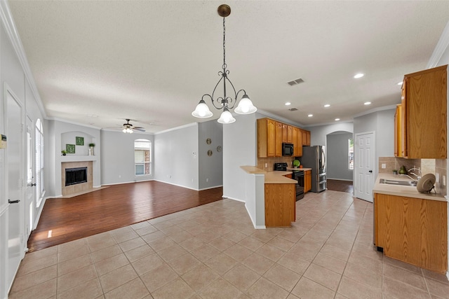 1106 Brook Ridge Ave, Allen, TX 75002 - kitchen featuring crown molding, black appliances, ceiling fan, light tile patterned floors, and light countertops