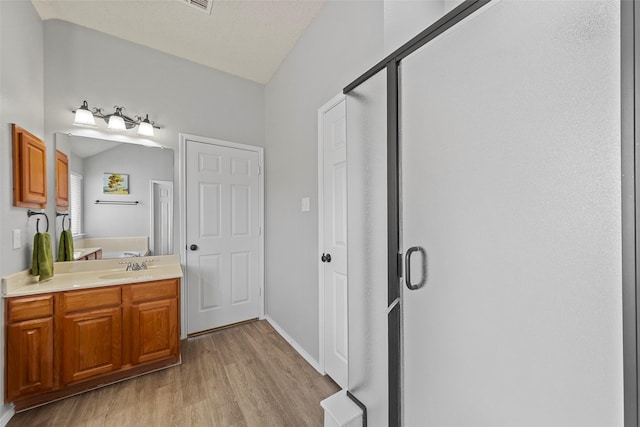 1106 Brook Ridge Ave, Allen, TX 75002 - full bathroom with wood finished floors, vanity, a shower stall, and baseboards