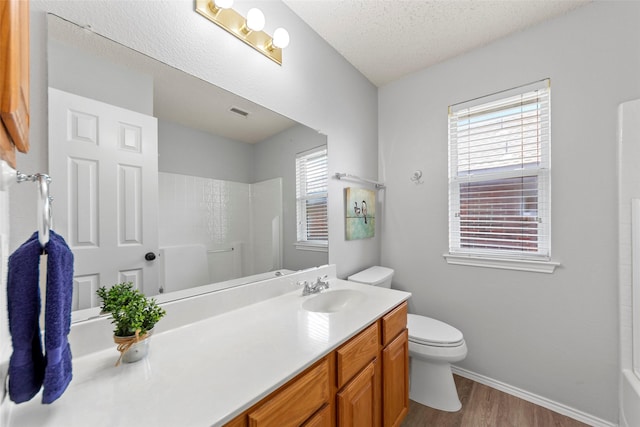 1106 Brook Ridge Ave, Allen, TX 75002 - full bath with toilet, wood finished floors, vanity, baseboards, and a textured ceiling