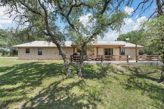 10048 E State Highway 36, Jonesboro, TX 76538 - rear view of property featuring a lawn, metal roof, a patio area, a chimney, and stone siding