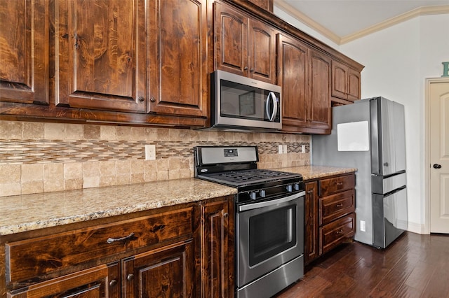 705 La Paloma Rd, Sanger, TX 76266 - kitchen with appliances with stainless steel finishes, light stone countertops, backsplash, dark wood-type flooring, and ornamental molding