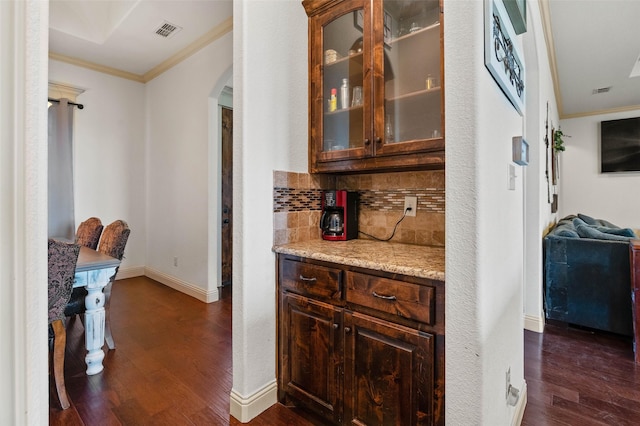 705 La Paloma Rd, Sanger, TX 76266 - bar with arched walkways, ornamental molding, dark wood-style flooring, backsplash, and baseboards