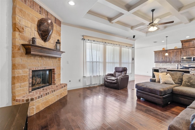 705 La Paloma Rd, Sanger, TX 76266 - living area with a large fireplace, a ceiling fan, dark wood-type flooring, beam ceiling, and recessed lighting
