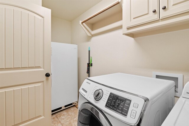 705 La Paloma Rd, Sanger, TX 76266 - washroom featuring cabinet space, separate washer and dryer, and light tile patterned flooring