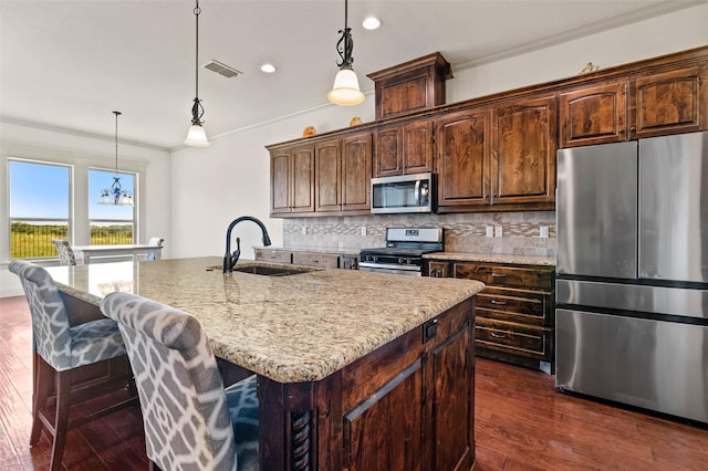 705 La Paloma Rd, Sanger, TX 76266 - kitchen with stainless steel appliances, recessed lighting, a sink, crown molding, and decorative backsplash