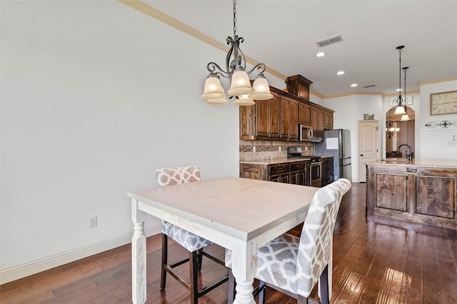 705 La Paloma Rd, Sanger, TX 76266 - dining space with a chandelier, dark wood-style flooring, ornamental molding, recessed lighting, and baseboards