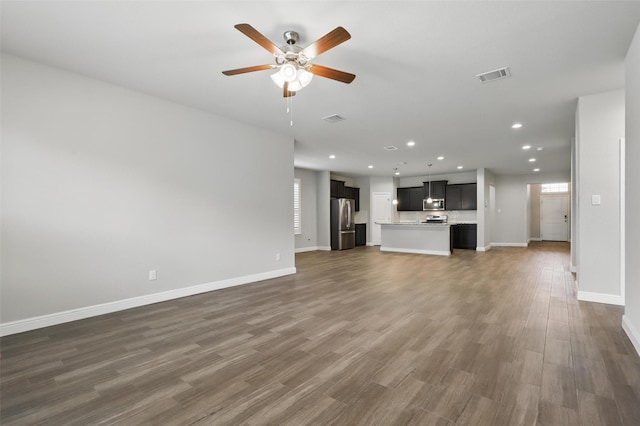 1253 Presidio Ln, Weatherford, TX 76087 - unfurnished living room with recessed lighting, a ceiling fan, baseboards, and dark wood-style floors