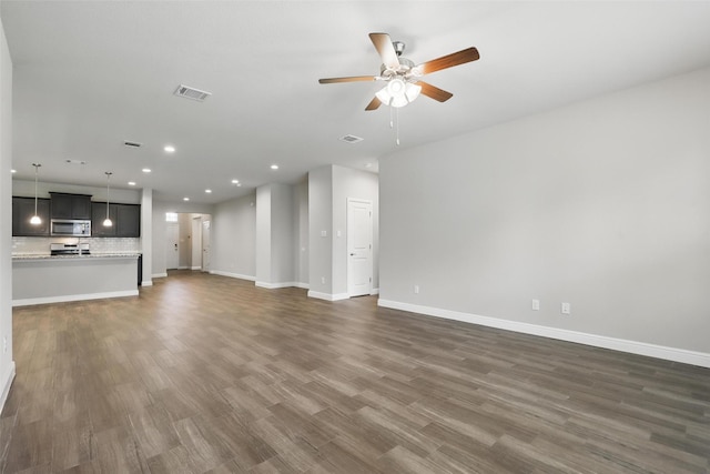 1253 Presidio Ln, Weatherford, TX 76087 - unfurnished living room featuring recessed lighting, a ceiling fan, baseboards, and dark wood-style floors