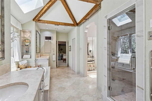 6015 Meadowcreek Dr, Dallas, TX 75248 - bathroom with a skylight, vaulted ceiling, two vanities, and a stall shower