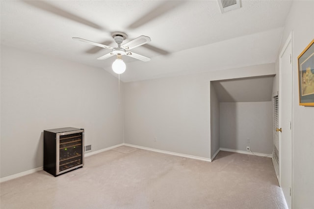6015 Meadowcreek Dr, Dallas, TX 75248 - spare room with beverage cooler, carpet floors, a ceiling fan, baseboards, and vaulted ceiling