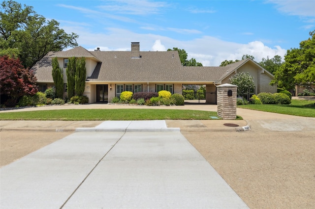 6015 Meadowcreek Dr, Dallas, TX 75248 - view of front of home with a front yard, a chimney, and roof with shingles