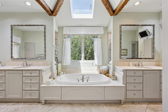 6015 Meadowcreek Dr, Dallas, TX 75248 - bathroom featuring two vanities, a skylight, a garden tub, and recessed lighting