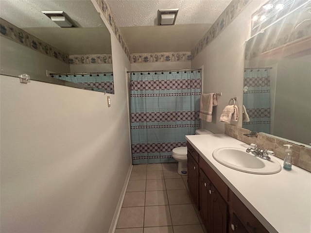 7834 Womack Rd, Shreveport, LA 71107 - full bathroom with a tile shower, vanity, toilet, tile patterned floors, and a textured ceiling