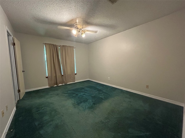 7834 Womack Rd, Shreveport, LA 71107 - empty room with a ceiling fan, dark colored carpet, baseboards, and a textured ceiling