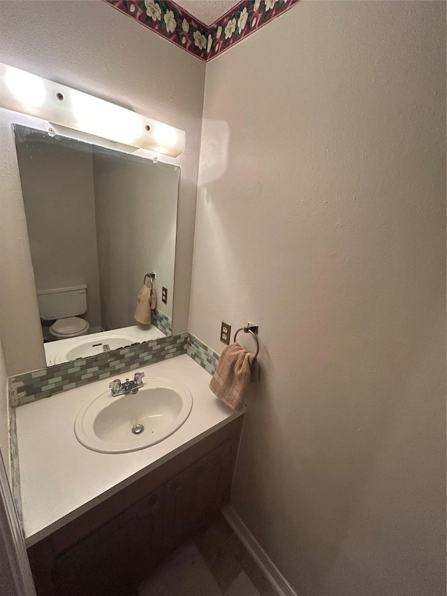 7834 Womack Rd, Shreveport, LA 71107 - half bath with vanity, backsplash, toilet, and baseboards