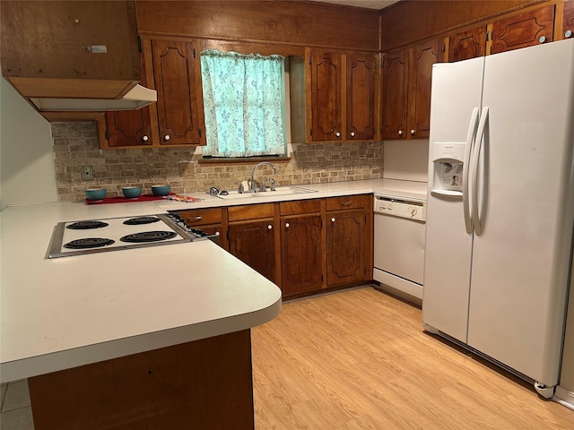 7834 Womack Rd, Shreveport, LA 71107 - kitchen featuring white appliances, a sink, decorative backsplash, and light countertops