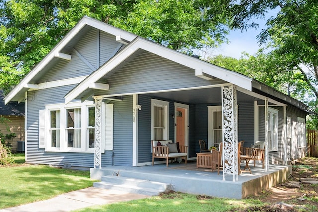 308 W Heard St, Cleburne, TX 76033 - view of front of home featuring covered porch, a front yard, and central air condition unit