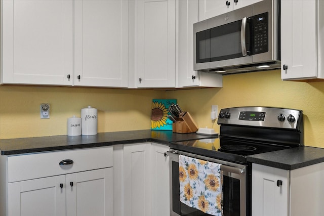 308 W Heard St, Cleburne, TX 76033 - kitchen with appliances with stainless steel finishes, white cabinetry, and dark countertops