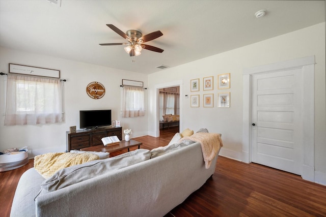 308 W Heard St, Cleburne, TX 76033 - living area featuring dark wood-style flooring, ceiling fan, and baseboards