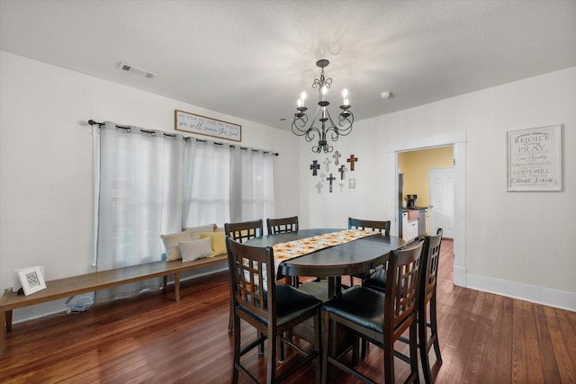 308 W Heard St, Cleburne, TX 76033 - dining space featuring a chandelier, dark wood-style floors, and baseboards