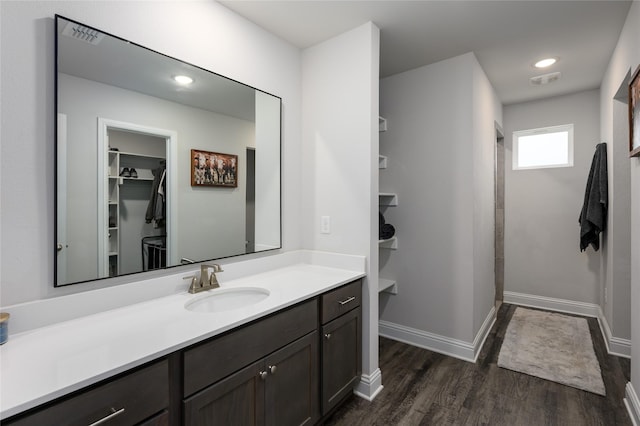 110 Thode St, Whitesboro, TX 76273 - full bath with vanity, wood finished floors, a spacious closet, and baseboards