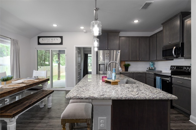 110 Thode St, Whitesboro, TX 76273 - kitchen featuring stainless steel appliances, a sink, light stone counters, backsplash, and dark wood-style flooring