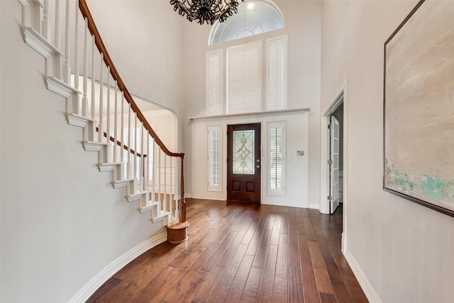 402 Thistle Ct, Southlake, TX 76092 - entrance foyer with a high ceiling, hardwood / wood-style flooring, stairway, a chandelier, and baseboards
