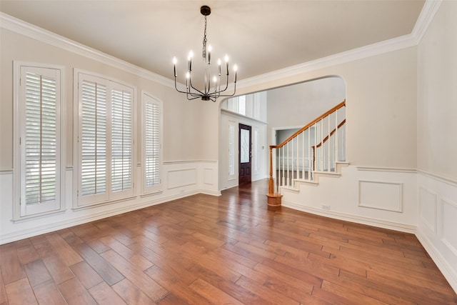 402 Thistle Ct, Southlake, TX 76092 - empty room featuring a chandelier, ornamental molding, stairs, wood-type flooring, and a wainscoted wall