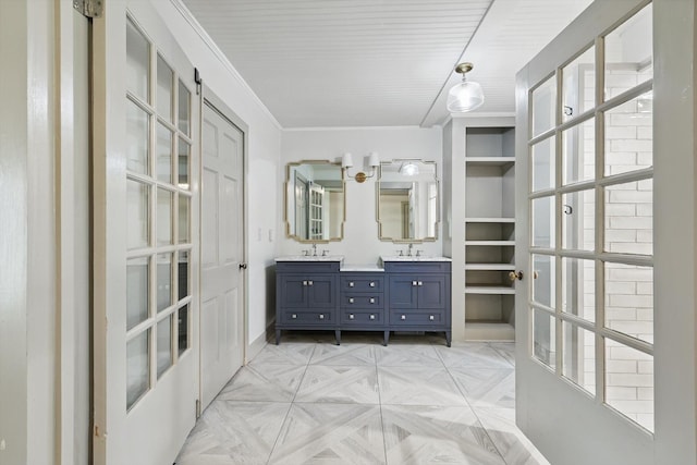 932 N Woods St, Sherman, TX 75092 - bathroom featuring double vanity, baseboards, and ornamental molding