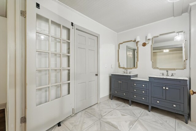 932 N Woods St, Sherman, TX 75092 - bathroom featuring double vanity, crown molding, and baseboards