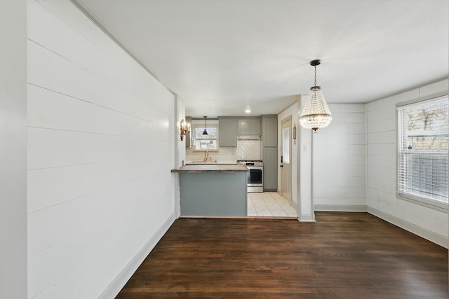 932 N Woods St, Sherman, TX 75092 - kitchen with stainless steel stove, gray cabinetry, healthy amount of natural light, and wood finished floors