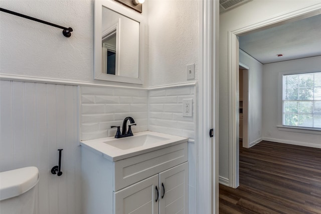 4104 Valentine St, Fort Worth, TX 76107 - half bath featuring vanity, toilet, wood finished floors, and wainscoting