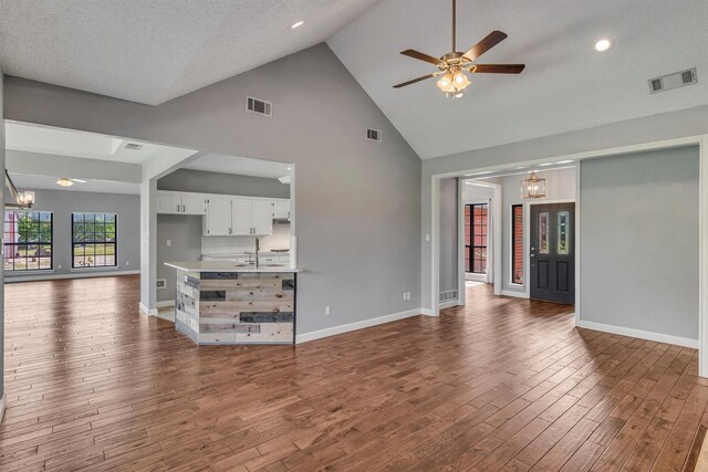 2310 N Walnut Grove Rd, Midlothian, TX 76065 - kitchen featuring white appliances, a peninsula, under cabinet range hood, a textured ceiling, and light countertops