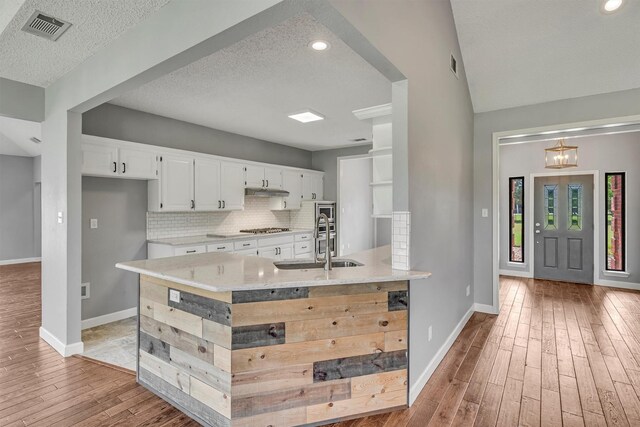 2310 N Walnut Grove Rd, Midlothian, TX 76065 - unfurnished bedroom with light colored carpet, a walk in closet, a textured ceiling, a ceiling fan, and connected bathroom